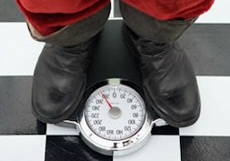 Santa Claus standing on scale Simple hacks for a merry fitness