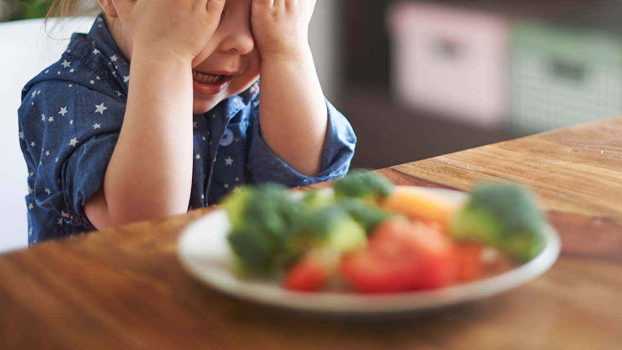 KidBroccoliGettyImages 474735668 - 10 Tips to Help Your Child Feel Positive With Vegetables